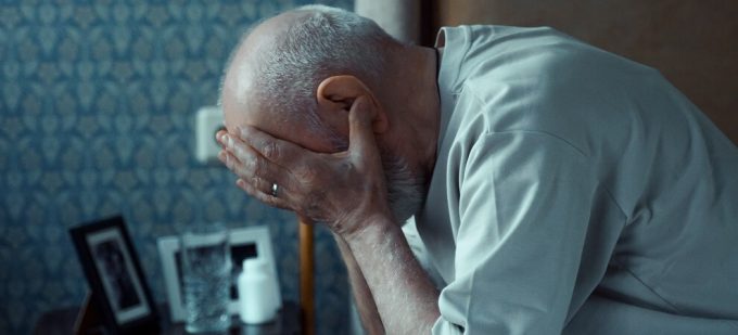 elderly man struggling to sleep, early sign of parkinson's disease